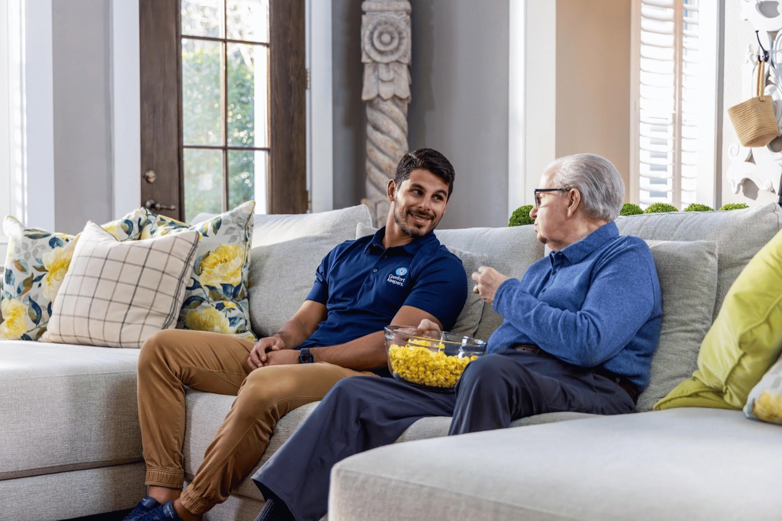A Petrichor support worker chatting warmly with a resident at home